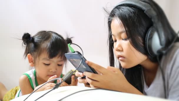 Los niños y la hermana juegan teléfono inteligente — Vídeos de Stock