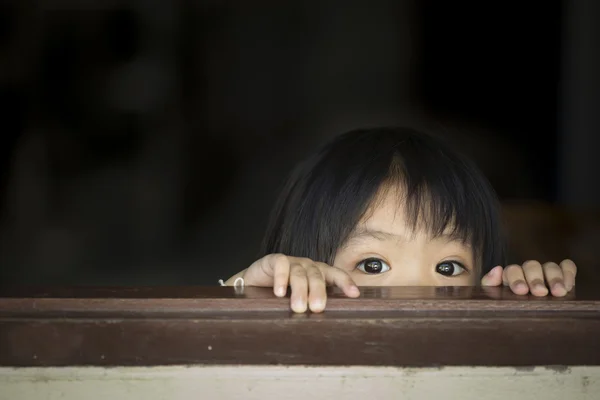 Asian baby behind the windows — Stockfoto