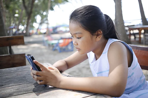 Asian teen to looking mobile phone — Stock Photo, Image