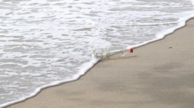 Bir içecek şişesi nazikçe dalgalanır. Denizdeki kirlilik.