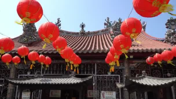 Panning red lantern blow by wind at temple. — Stock Video