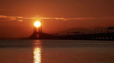Georgetown, Penang, Malaysia - Oct 22 2018: Timelapse the silhouette Penang bridge structure in morning.