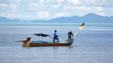 Kuala Perlis, Perlis, Malaysia - Oct 25 2018: Fishermen pull the net to collect.