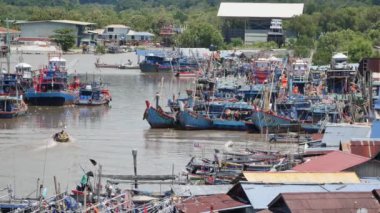 Sungai Perlis, Perlis, Malaysia - Oct 25 2018: A boat go back the jetty park with a lot of fishing boat and ship.
