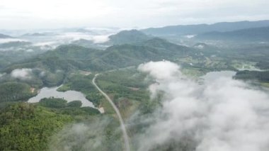 Sik, Kedah, Malaysia - Dec 15 2018: Aerial the road lead to Tasik beris over cloud.