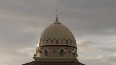 Timelapse sunset over architecture dome of mosque.