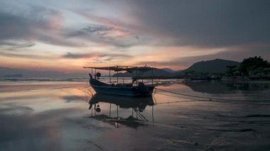 Timelapse view reflection of boat during low tide at Permatang Damar Laut, Penang
