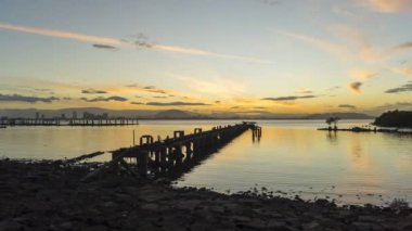 Timelapse view sunrise over old abandoned fisherman pier