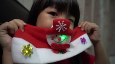 Küçük çocuk Noel hediyesiyle mutlu kardan adam şapkasıyla
