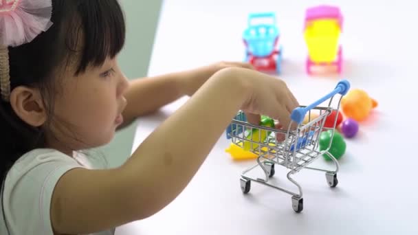 Chinese Little Girl Enter Fake Food Shopping Cart — Stock Video