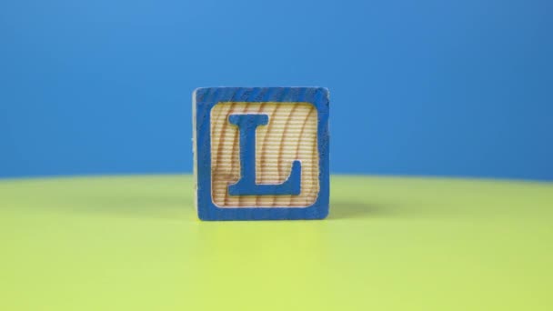 Close up shot letter L alphabet wooden block on surface