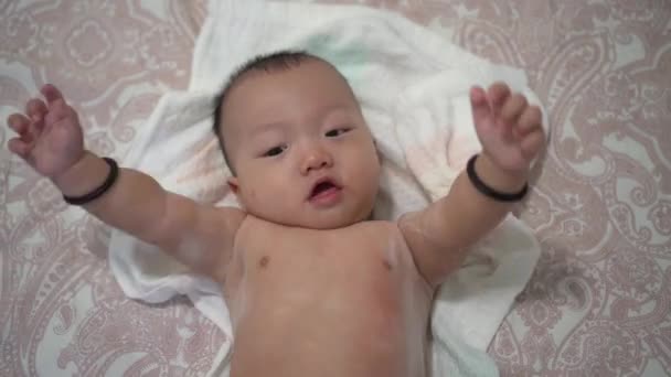 Naked Baby Lay Bed Raise Hand Look Camera — Stock Video