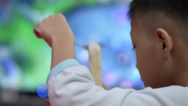 Chinese Kid Eat Noodle Watch Television — Stock Video