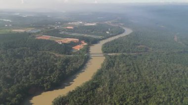 Üzerinde köprü olan bir nehir. Nehir kahverengi. Hava görüntüsü Kota Tinggi, Johor