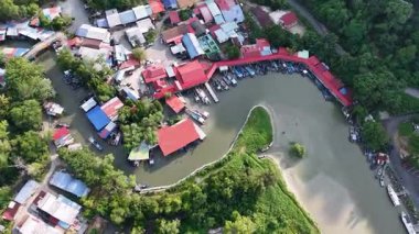 İnsansız hava aracı görüntüleri Pulau Betong balıkçı köyünü, tekneleri, kırmızı çatıları ve mangrov kıyı şeridini gösteriyor.