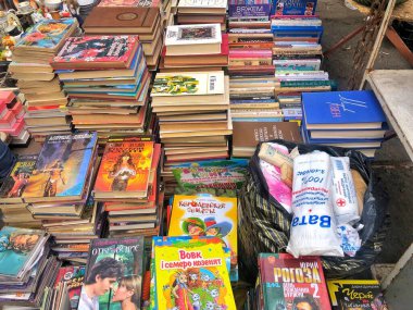 March 27, 2021, Ukraine, Kharkov. Swap meet, sale of old things. Large collection of books, stacks of children's and adult books