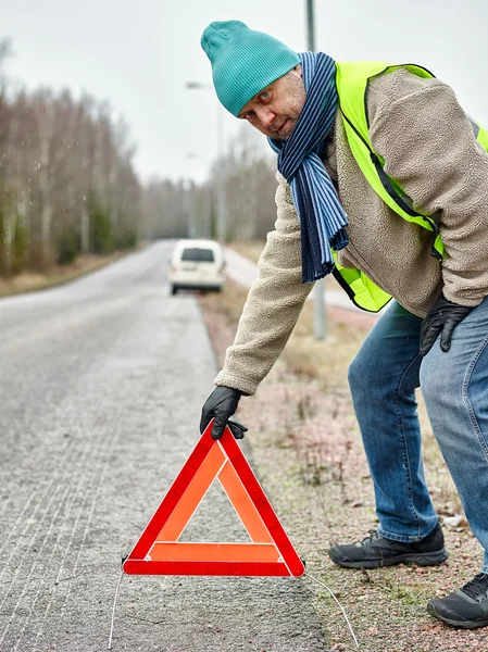 Male and warning triangle — Stock Photo, Image
