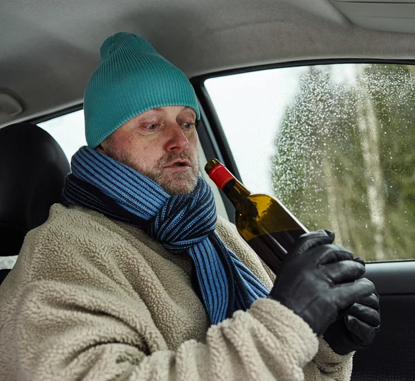 Driver and wine bottle — Stock Photo, Image