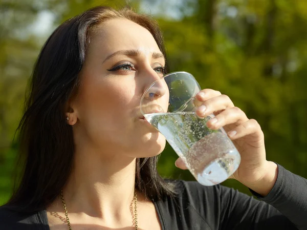 Woman with glass of sparkling water — Stock Fotó