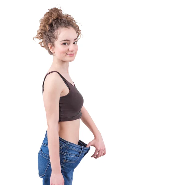 Skinny girl and baggy jeans — Stock Photo, Image