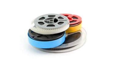 Beyaz arka plan üzerinde dönen film makaraları