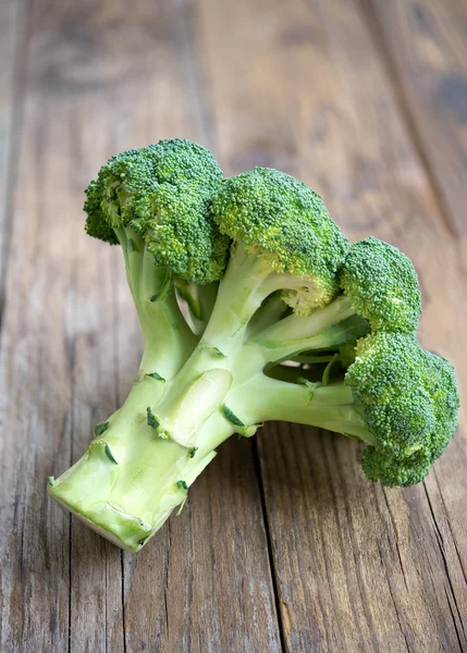 Broccoli on wooden table — Stock Photo, Image