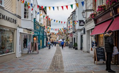 Shops and bunting in pedestrain only area in Butchers Row in Salisbury, Wiltshire, UK on 29 June 2021