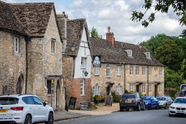 The George Inn and pub sign in Lacock, Wiltshire, UK on 6 July 2021