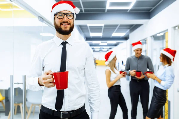 Jovem Empresário Vestindo Chapéu Papai Noel Segurando Caneca Vermelha Com — Fotografia de Stock