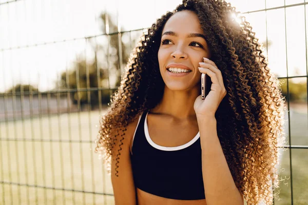 fitness woman, in sportswear, talking on a mobile phone, outdoors, sports, healthy lifestyle