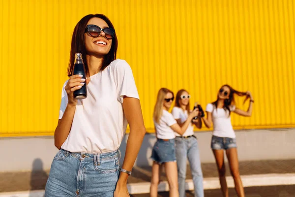 Νεαρή Γυναίκα Γυαλιά Ηλίου Πίνει Ένα Ποτό Μια Ομάδα Φίλων — Φωτογραφία Αρχείου
