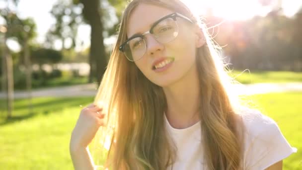 Giovane bella donna felice in occhiali sorridente all'aperto — Video Stock