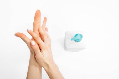 Hands applying hand sanitizer against coronavirus, on white background