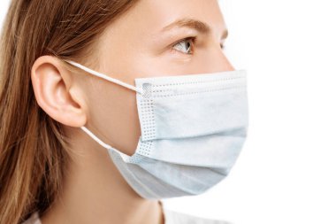Young woman using medical protective mask to protect health and prevent influenza virus, epidemic and infectious diseases, on white background
