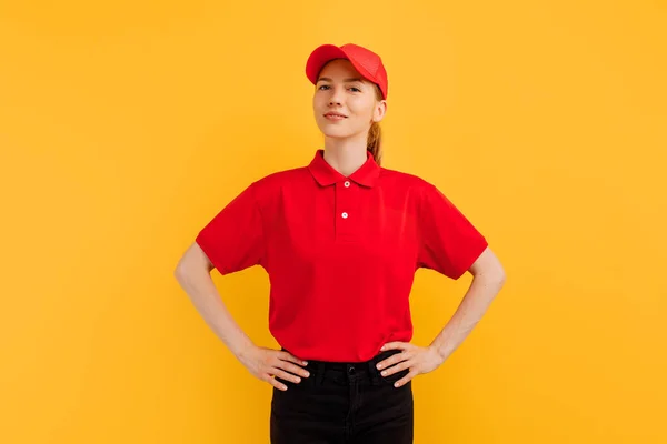 Lächelnde Junge Kurierin Roter Uniform Posiert Auf Gelbem Studiohintergrund Lieferkonzept — Stockfoto