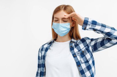 Genç bir kadının soğuk ve yüksek ateşi var, elini alnına koyup vücudunun sıcaklığını kontrol ediyor.