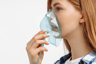 Young woman holding inhalation mask in front of her face, on white background lung disease recovery treatment clipart