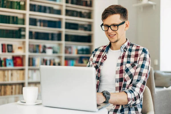 Joven Gafas Negocios Sienta Una Mesa Café Trabaja Ordenador Portátil — Foto de Stock