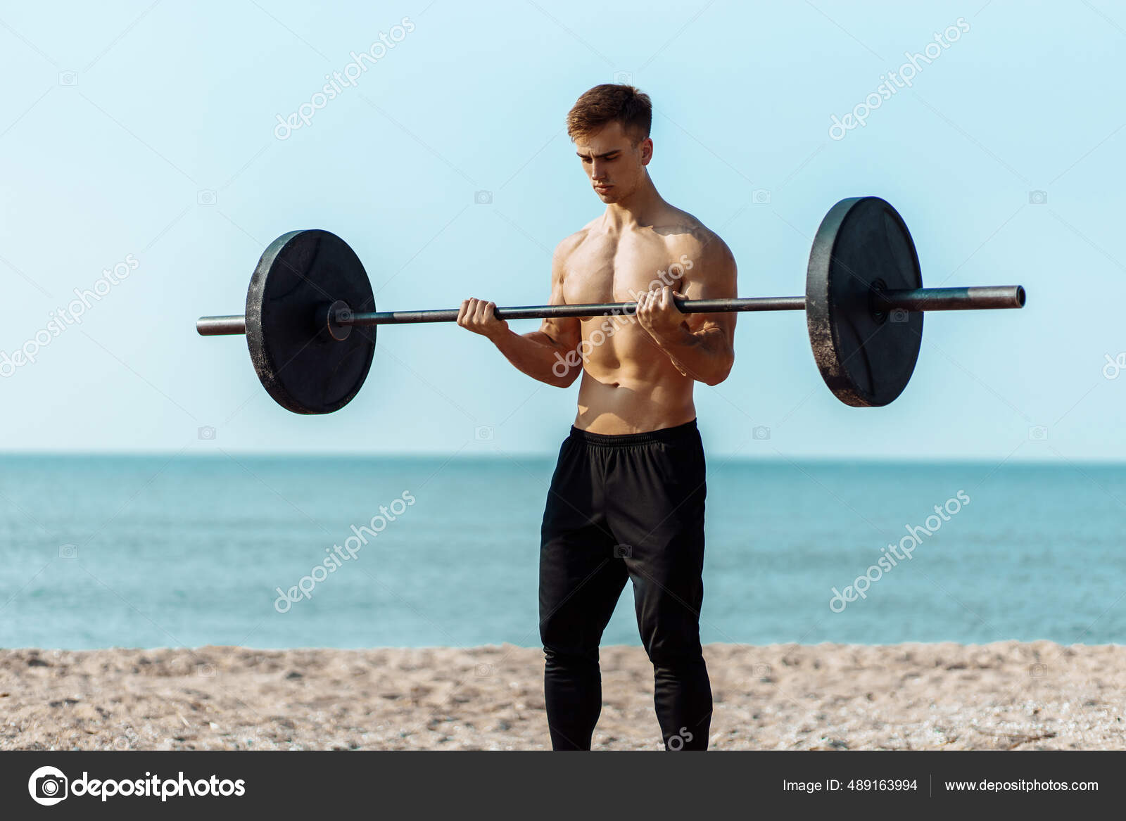A bulky, muscular guy on the beach