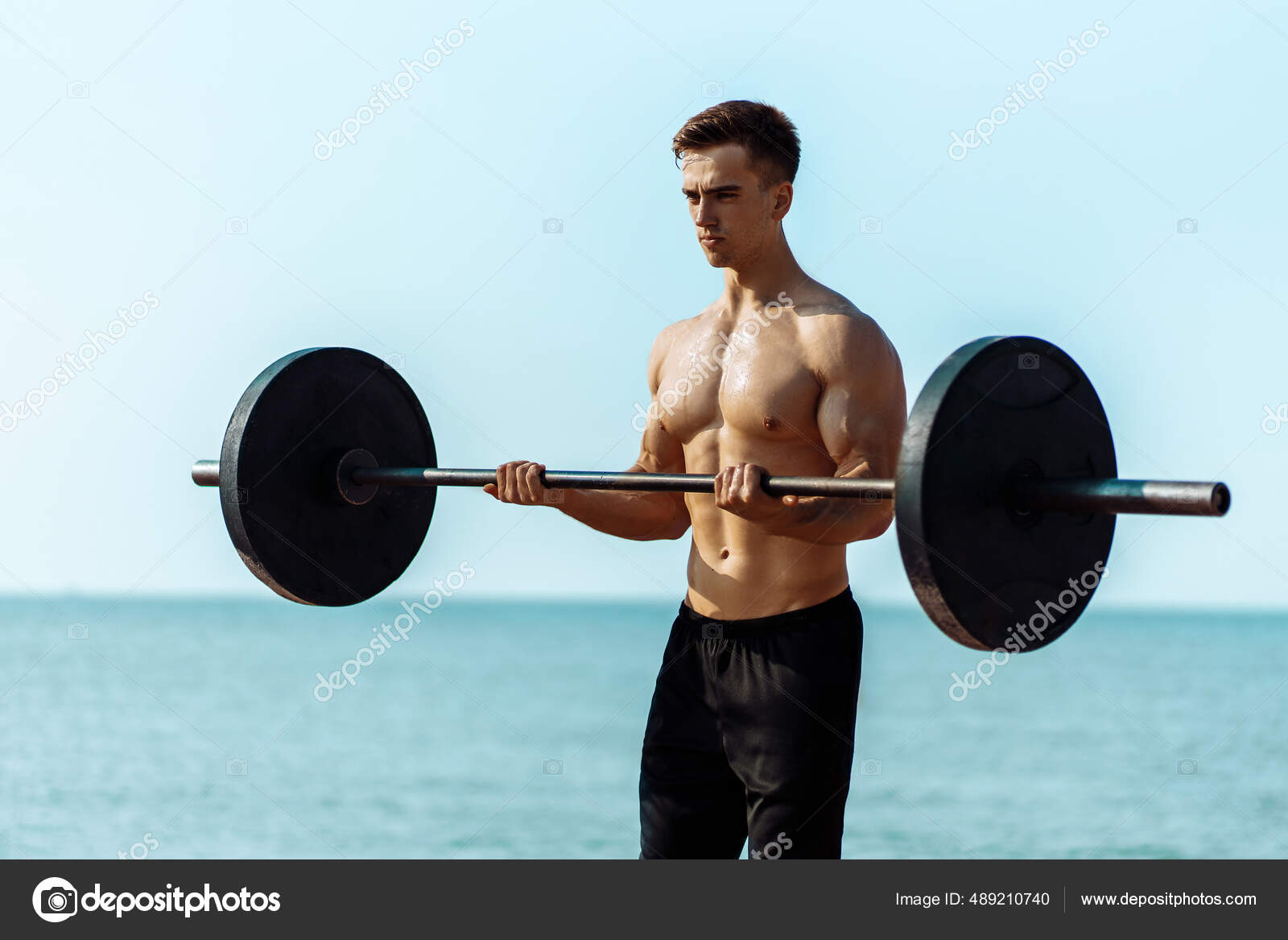 A bulky, muscular guy on the beach