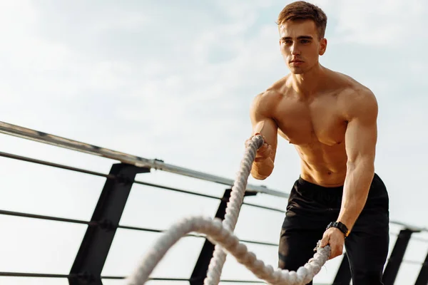 Muskelkräftiger Fitnessmann Mit Trainingsseilen Für Outdoor Sportarten Auf Der Seebrücke — Stockfoto