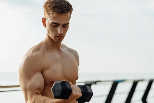 肌肉发达的强壮男子 赤身裸体锻炼身体 在码头的桥上展示六只腹肌立方体 — 图库照片