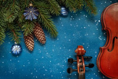 Two Old violins and fir-tree branches with Christmas decor  clipart