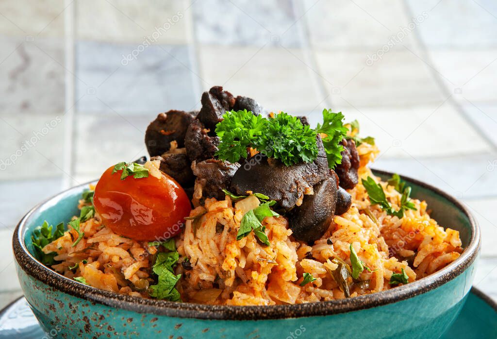 Indigenous Ghanaian, African-Caribian food Jollof Rice with tomato sause, regional spices, chicken meat and offal. 