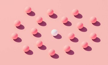 Standing out from the crowd minimal concept. A lot of pink spheres surrounds a white sphere, symbolizes individuality and to be one of a kind. 3D Rendering. clipart
