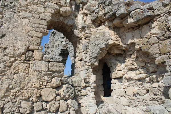 ruins of the old ancient fortress sights in the Crimea / photo of the old historical fortress. tourist attraction in Crimea. a large ancient building has been destroyed. through the openings in the walls, you can see the blue sky.