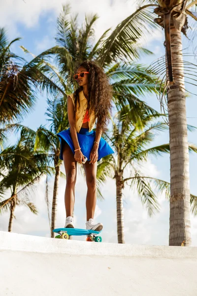 Красива чорна дівчина-підліток в яскравому вбранні їде на тропічних — стокове фото