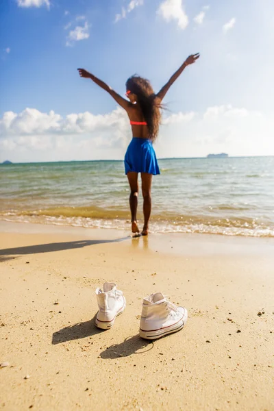 Hermosa adolescente negro chica en zapatillas blancas en la arena de ser — Foto de Stock