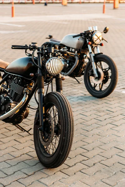 Two black and silver vintage custom motorcycles caferacers