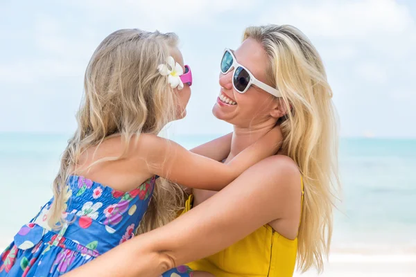 Cute girl and beautiful mother on the beach — Stock Photo, Image
